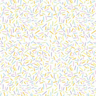 Pattern of colorful sprinkles on a white background
